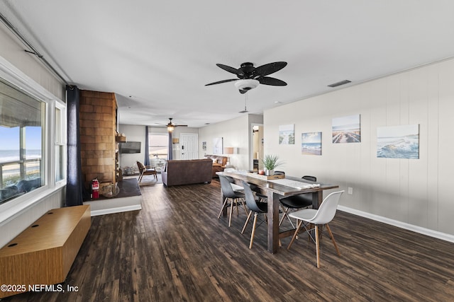 dining space with visible vents, baseboards, and wood finished floors