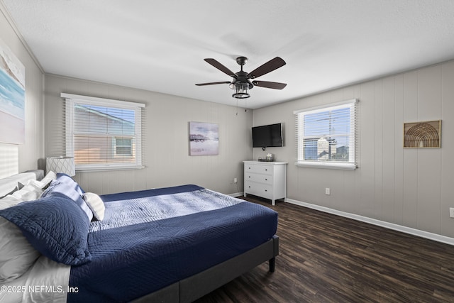 bedroom with a ceiling fan, wood finished floors, and baseboards