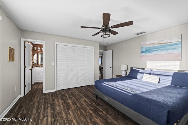 bedroom featuring a ceiling fan, wood finished floors, visible vents, ensuite bath, and a closet