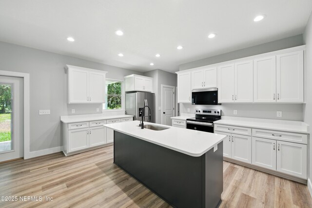 207 Palmetto Ave N, Florahome, FL 32140 - kitchen with appliances with stainless steel finishes, a sink, plenty of natural light, a center island with sink, and recessed lighting