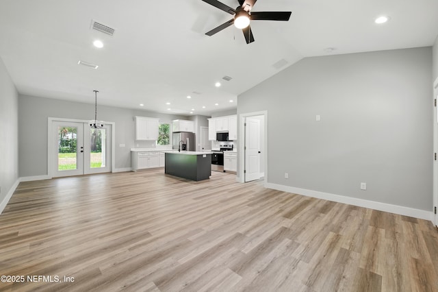 207 Palmetto Ave N, Florahome, FL 32140 - unfurnished living room featuring ceiling fan, recessed lighting, light wood-style floors, lofted ceiling, and baseboards