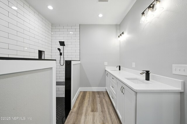 207 Palmetto Ave N, Florahome, FL 32140 - full bathroom featuring a walk in shower, wood finished floors, recessed lighting, double vanity, and baseboards