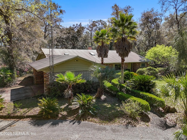 view of side of property with metal roof