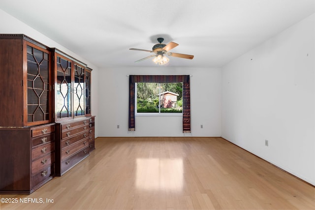 unfurnished bedroom with light wood finished floors and a ceiling fan