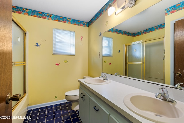 full bathroom with a sink, baseboards, toilet, and tile patterned flooring