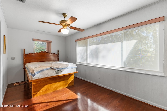 bedroom featuring ceiling fan, baseboards, and wood-type flooring