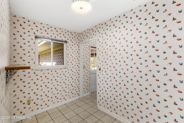 bathroom with tile patterned floors, wallpapered walls, and baseboards