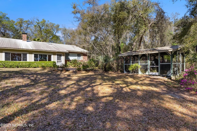 view of yard featuring a sunroom