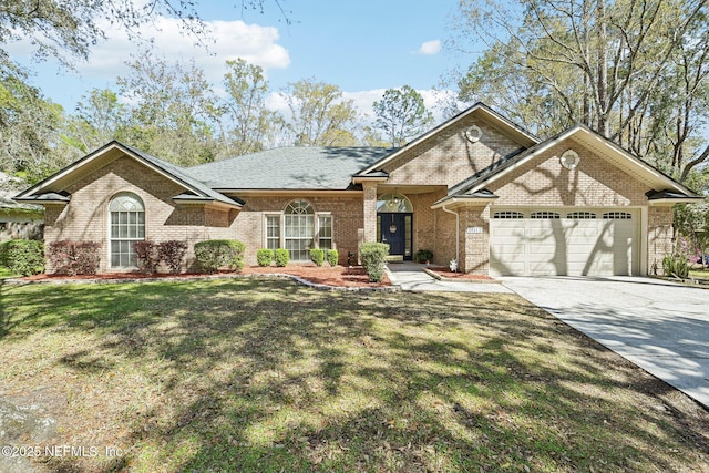 view of front of house with brick siding, a shingled roof, a front lawn, concrete driveway, and a garage