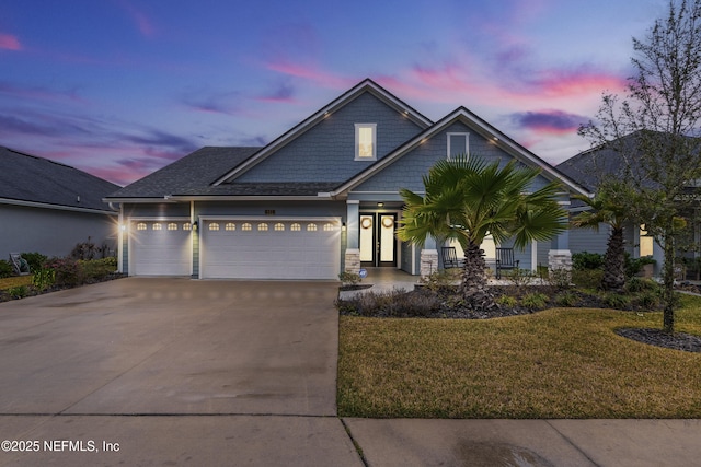 view of front of house featuring a yard, concrete driveway, and an attached garage