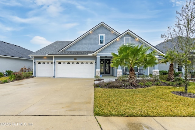 view of front of home with a front lawn, a garage, and driveway