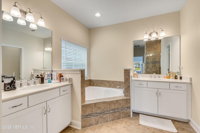 bathroom with a garden tub, tiled shower, tile patterned floors, and a sink