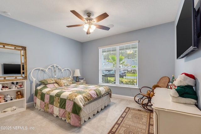 bedroom with light colored carpet, a ceiling fan, and baseboards