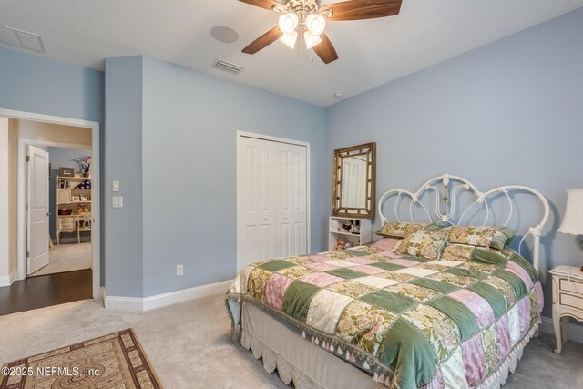 bedroom with carpet, visible vents, a closet, and baseboards