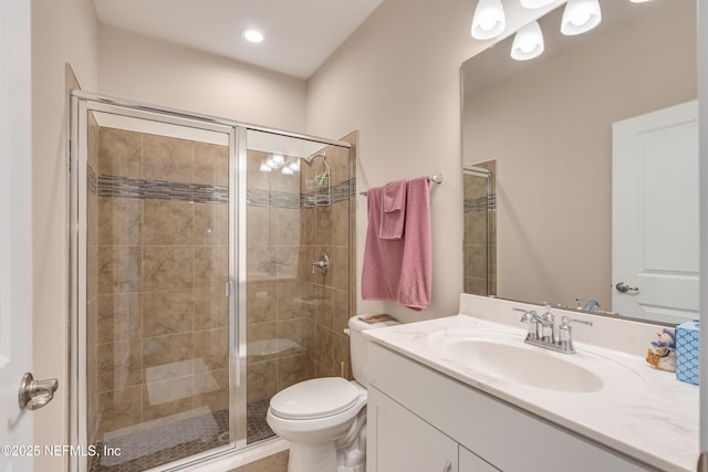 bathroom with vanity, toilet, and a stall shower