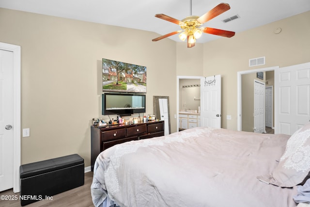 7540 Scarlet Ibis Ln, Jacksonville, FL 32256 - bedroom with lofted ceiling, wood finished floors, visible vents, and connected bathroom
