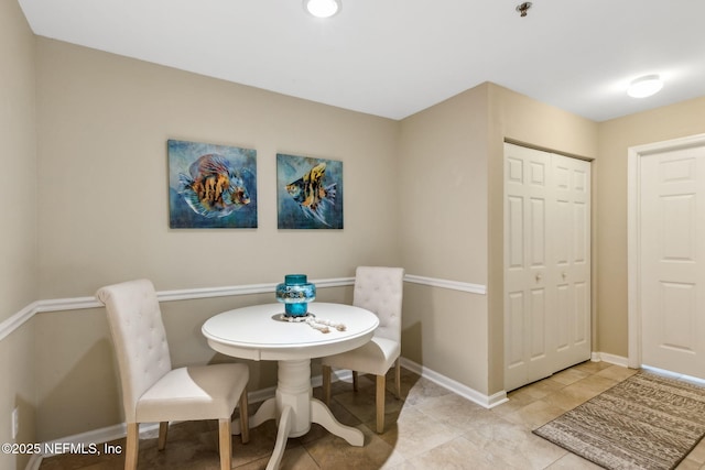 dining room featuring light tile patterned floors and baseboards