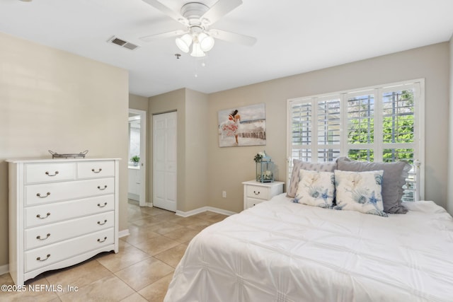 bedroom featuring light tile patterned floors, visible vents, baseboards, and ceiling fan