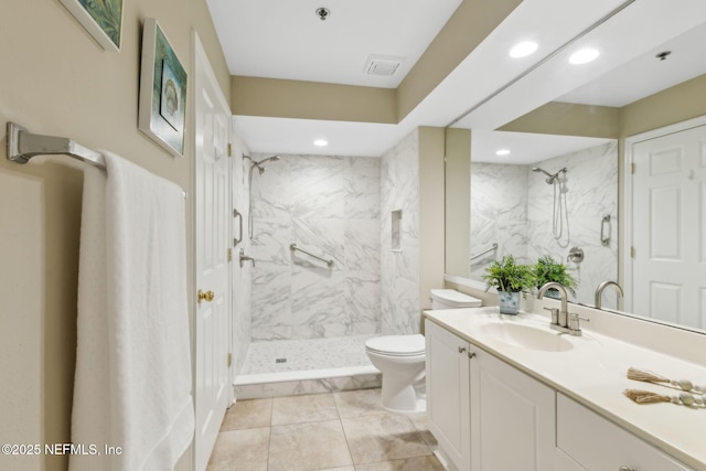 bathroom with a marble finish shower, toilet, visible vents, and vanity