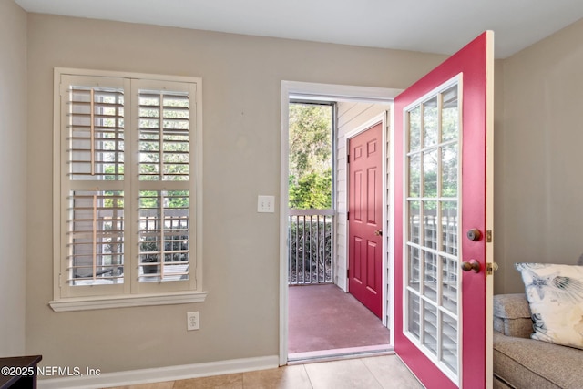 foyer entrance with baseboards and tile patterned flooring