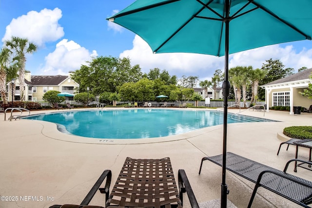 pool featuring a patio area and fence