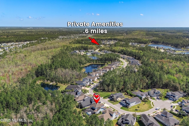 aerial view with a residential view, a view of trees, and a water view