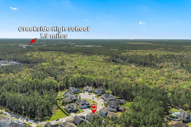 birds eye view of property featuring a residential view and a forest view