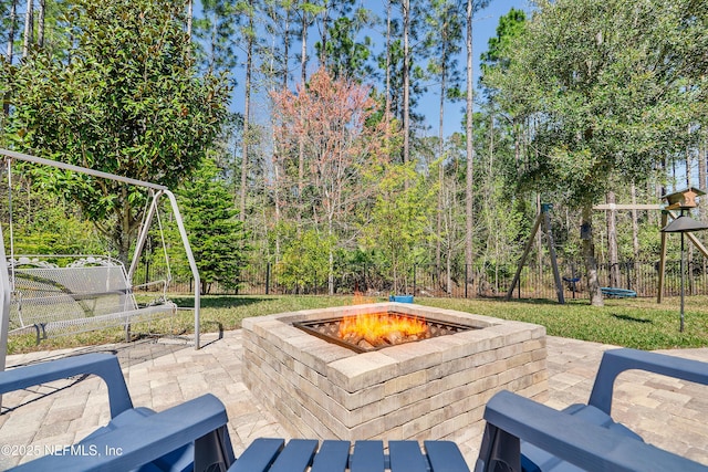 view of patio / terrace featuring a fire pit and fence