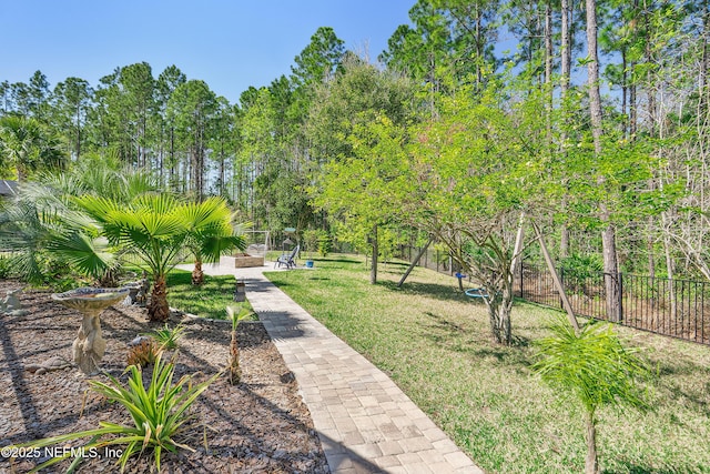 surrounding community with a yard and fence