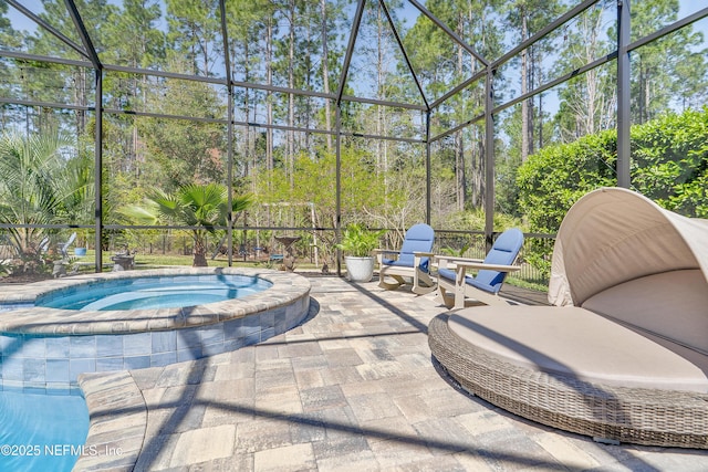 view of swimming pool with glass enclosure, a patio, and an in ground hot tub