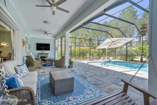 pool featuring an outdoor living space, glass enclosure, and a patio