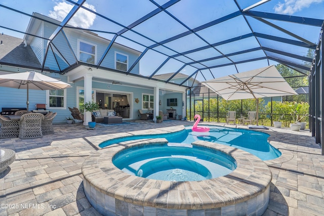 view of swimming pool featuring a patio, a lanai, and a pool with connected hot tub