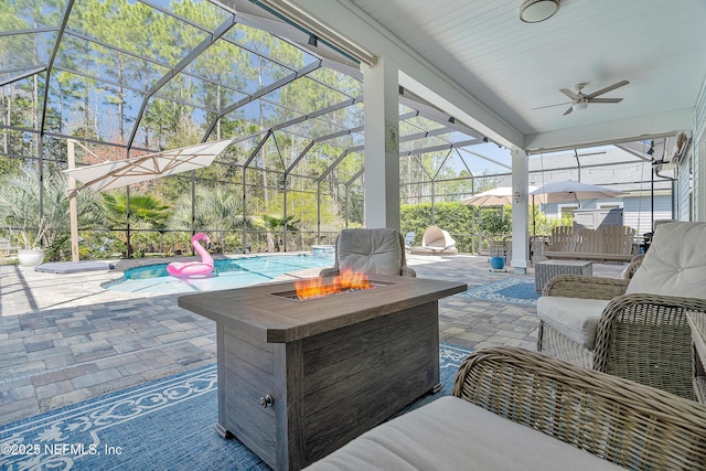 view of patio / terrace with an outdoor pool, glass enclosure, a ceiling fan, and an outdoor fire pit