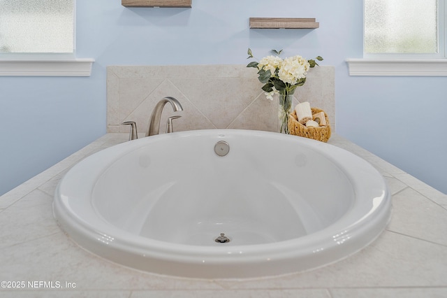 full bathroom featuring a healthy amount of sunlight and a freestanding bath