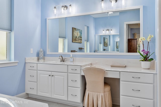 bathroom featuring vanity and baseboards