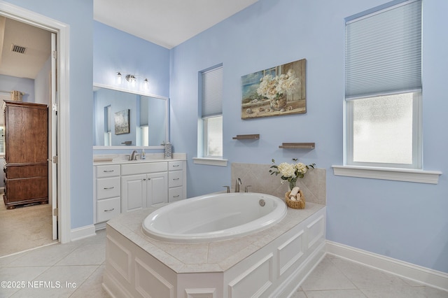 bathroom with tile patterned floors, visible vents, a bath, and a wealth of natural light