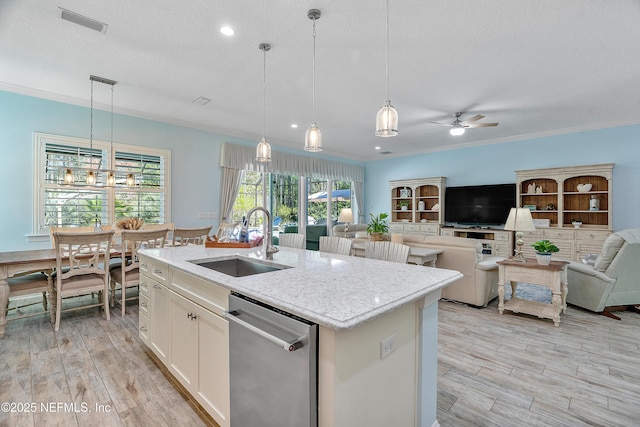 kitchen featuring a sink, stainless steel dishwasher, crown molding, and light wood finished floors