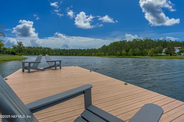 view of dock with a forest view and a water view