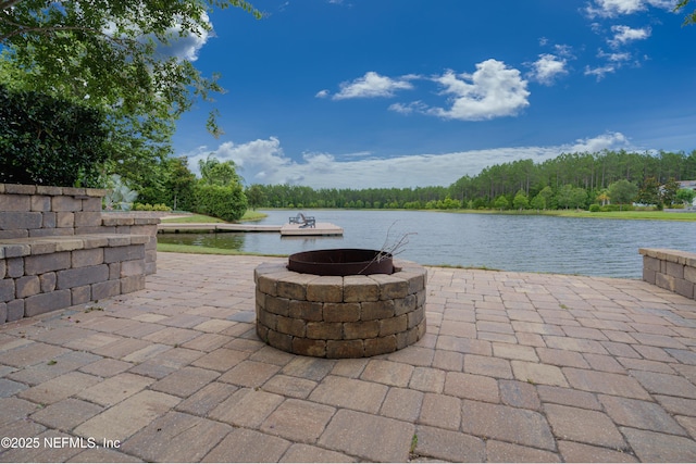 view of patio / terrace with a fire pit and a water view