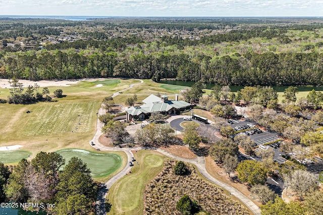 aerial view featuring golf course view and a wooded view