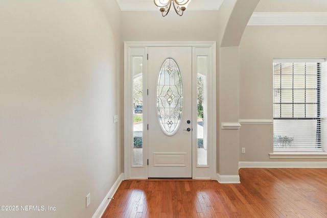 entryway featuring plenty of natural light, hardwood / wood-style flooring, and ornamental molding