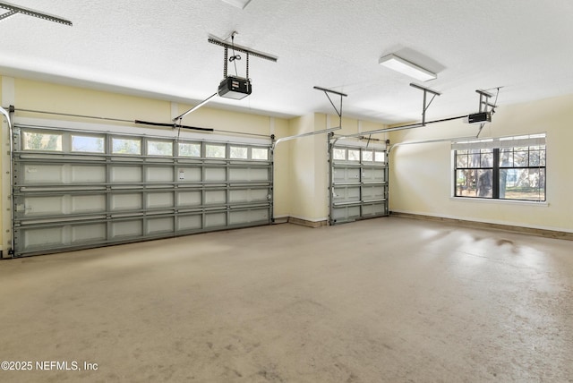 garage featuring a garage door opener and baseboards