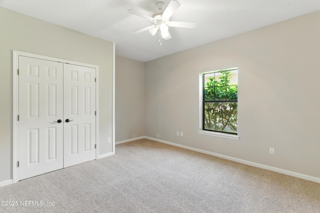 unfurnished bedroom featuring a closet, carpet floors, and baseboards