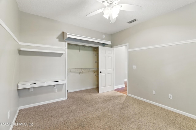 unfurnished bedroom featuring visible vents, carpet floors, baseboards, and a closet