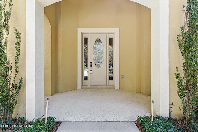 doorway to property with stucco siding