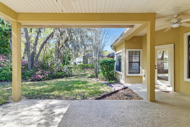 view of yard with a patio area, a ceiling fan, and fence