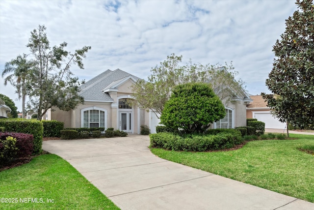 523 Lakeway Dr, Saint Augustine, FL 32080 - view of front facade featuring a front lawn, driveway, and stucco siding