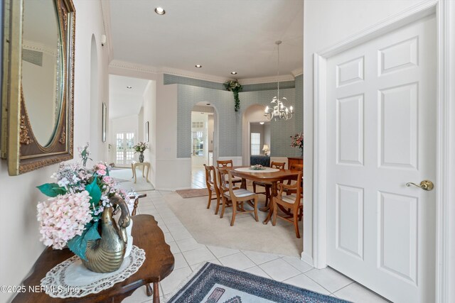 523 Lakeway Dr, Saint Augustine, FL 32080 - entrance foyer with ornamental molding, arched walkways, a notable chandelier, and wainscoting