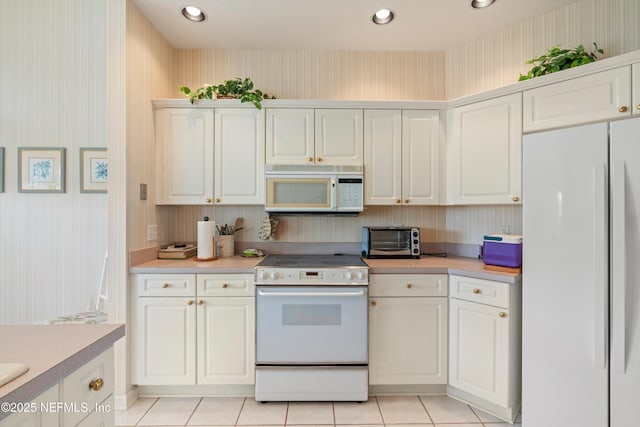 523 Lakeway Dr, Saint Augustine, FL 32080 - kitchen with light countertops, wallpapered walls, a toaster, and white appliances