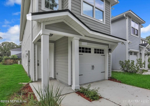 exterior space featuring a lawn and a garage